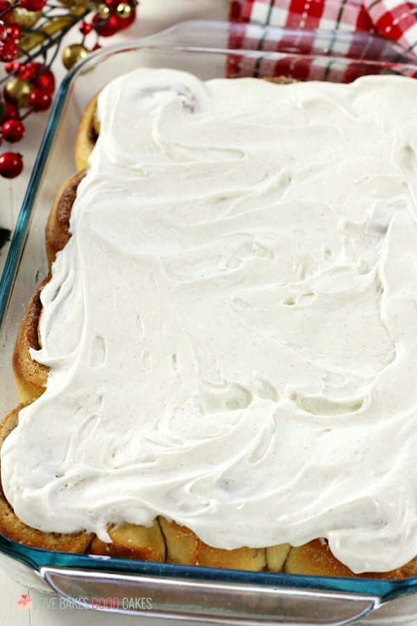 Eggnog Cinnamon Rolls in a baking dish with white creme frosting.