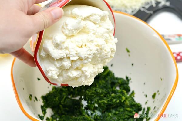 adding ricotta cheese to mixing bowl with spinach for Spinach Ricotta Manicotti