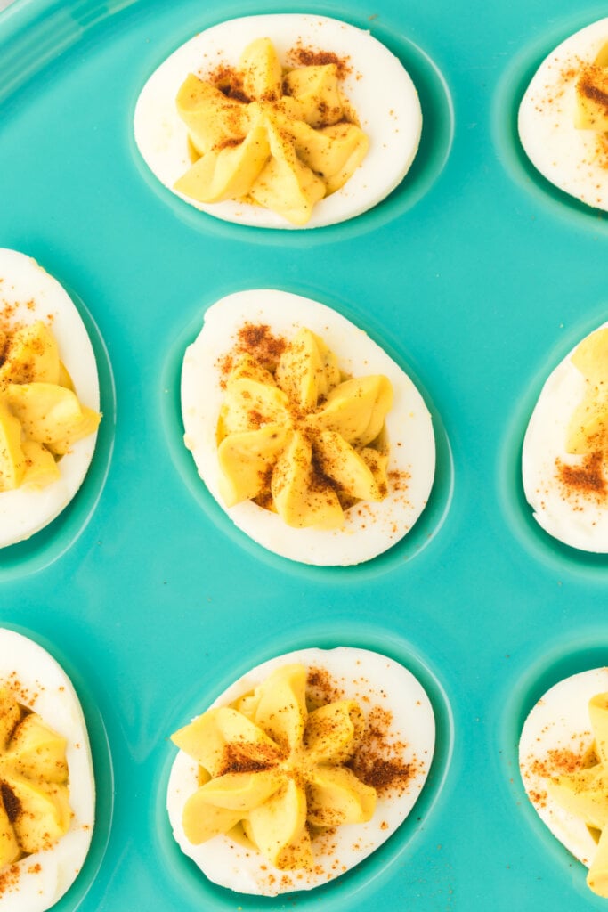 closeup of three deviled eggs on egg platter