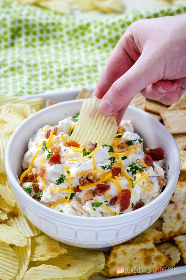 Potato chip being dipped into dip