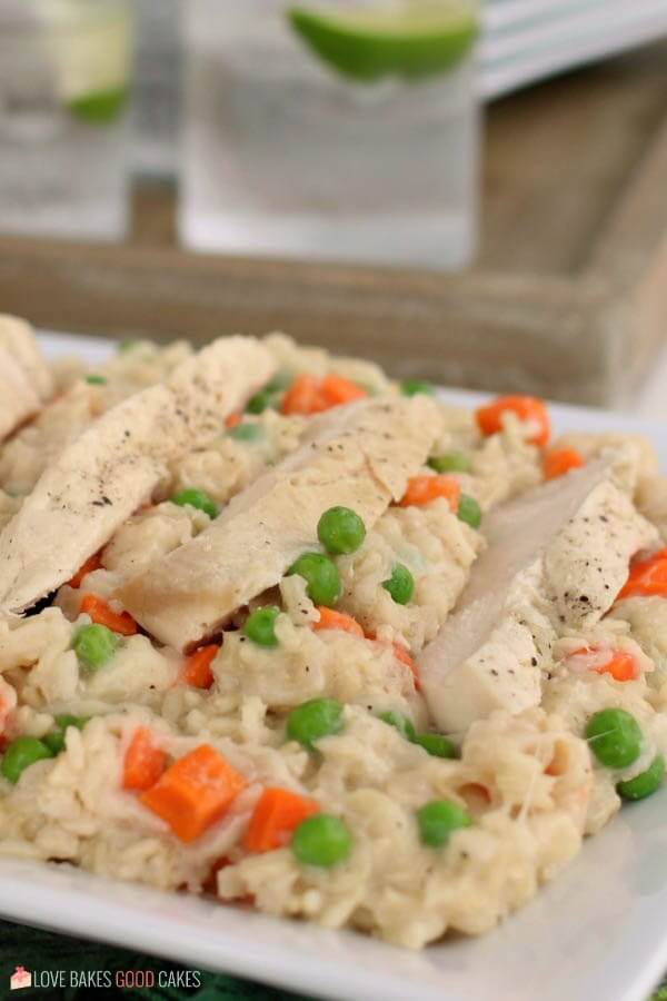 Slow Cooker Chicken and Rice is a cheesy chicken and rice casserole made in a slow cooker. Throw it together, set it, and forget it. Chicken and rice cooked in a slow cooker served on a platter up close.