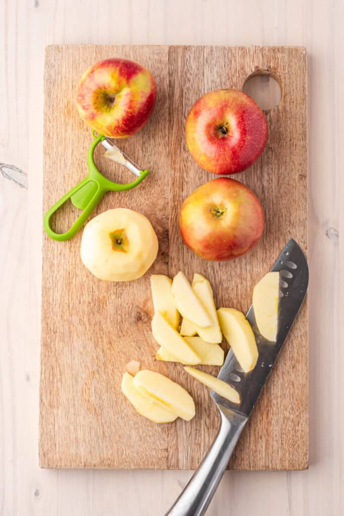Peeling and slicing fresh Honeycrisp apples for homemade fried apples.