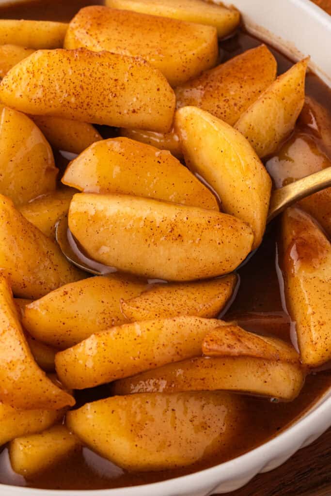 Close-up of tender Southern Fried Apples coated in a buttery cinnamon brown sugar sauce.