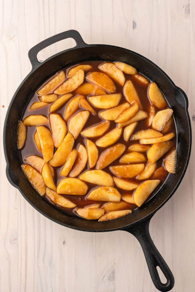 Southern fried apples cooking in a rich cinnamon brown sugar syrup.