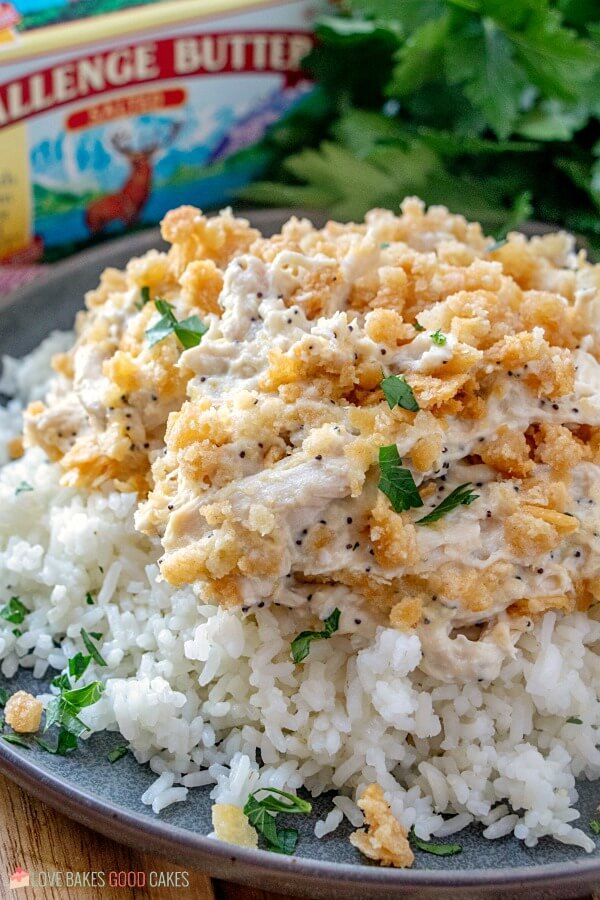 This Poppy Seed Chicken Casserole has a creamy poppy seed sauce filled with shredded chicken and topped with a rich buttery cracker crumb crust. Challenge Butter & Poppy Seed Chicken Casserole on a plate.