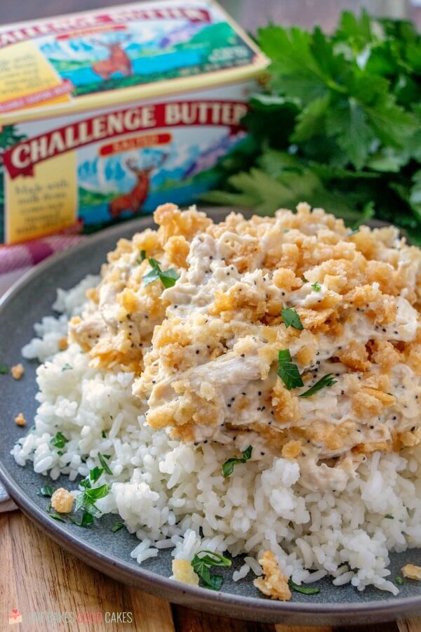 This Poppy Seed Chicken Casserole has a creamy poppy seed sauce filled with shredded chicken and topped with a rich buttery cracker crumb crust. Poppy Seed Chicken Casserole on a plate.