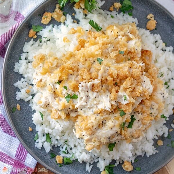 This Poppy Seed Chicken Casserole has a creamy poppy seed sauce filled with shredded chicken and topped with a rich buttery cracker crumb crust. Poppy Seed Chicken Casserole on a plate.