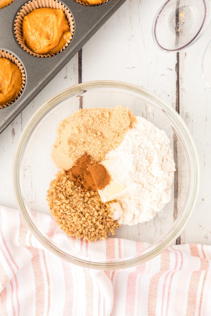 Bowl with flour, brown sugar, nuts, cinnamon, and butter arranged before mixing the crumb topping