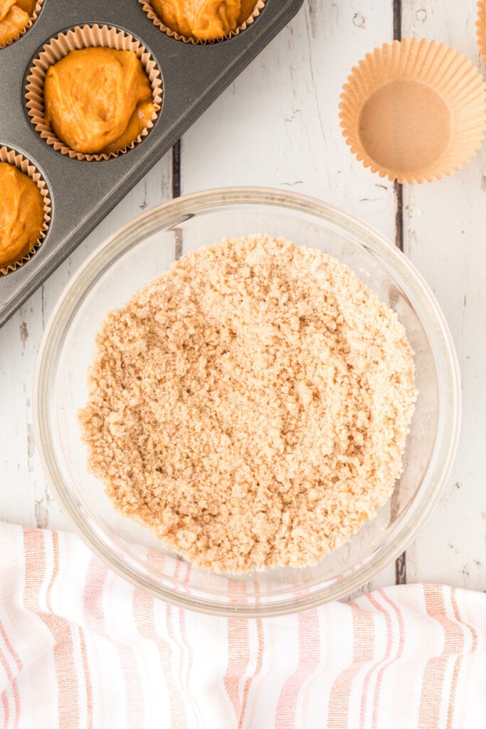 Crumb topping fully mixed into a fine, sandy texture in a clear glass bowl