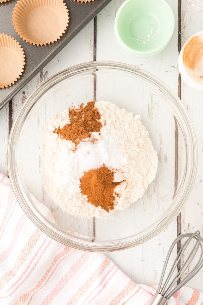 Bowl of dry ingredients including flour, spices, baking soda, and baking powder before mixing