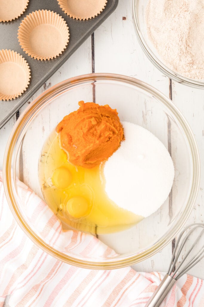 Bowl with pumpkin, eggs, sugar, and oil before mixing the wet ingredients