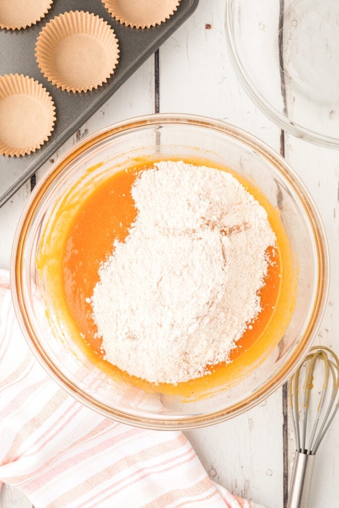 Dry mixture added on top of the wet mixture in a glass bowl before folding together