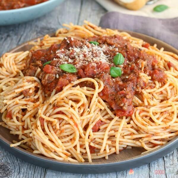 Slow Cooker Spaghetti Sauce that is as easy as throwing everything into your slow cooker. Economical and great for busy weeknights. Slow Cooker Spaghetti Sauce with pasta on a plate close up.