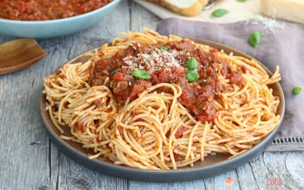 Slow Cooker Spaghetti Sauce that is as easy as throwing everything into your slow cooker. Economical and great for busy weeknights. Slow Cooker Spaghetti Sauce with pasta on a plate.