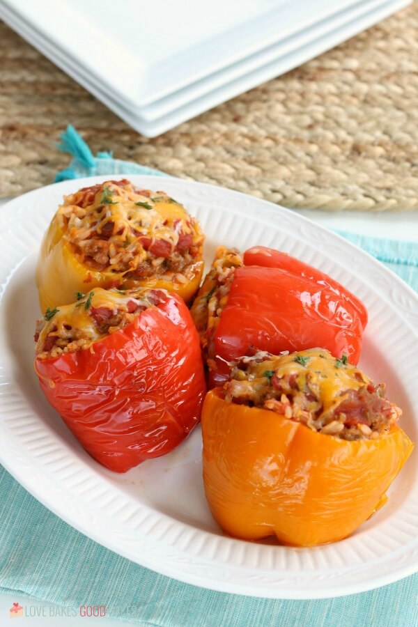 Stuffed Peppers Recipe using ground beef or sausage in the Crockpot is an easy weeknight meal. Best ever Slow Cooker Stuffed Pepper Recipe. Slow Cooker Stuffed Peppers on a plate.