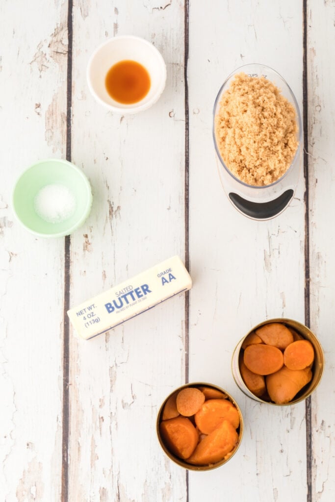 Ingredients for candied yams including canned yams, brown sugar, butter, vanilla, and salt