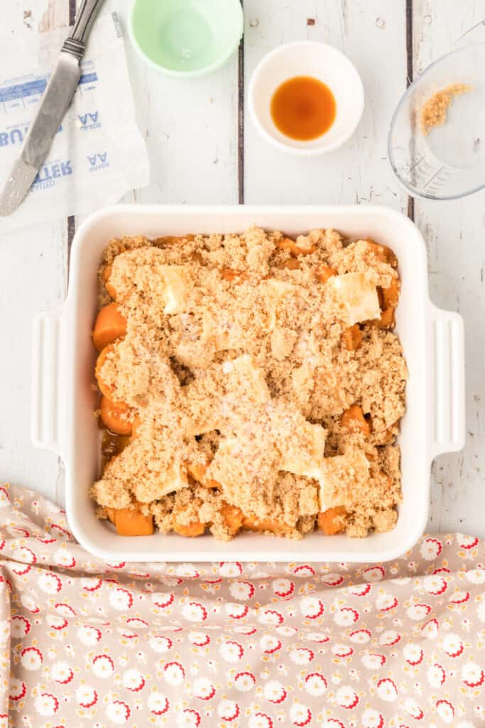 Canned yams topped with butter and brown sugar before baking