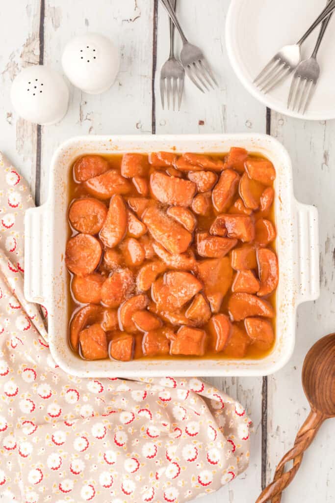 Baked candied yams coated in a buttery brown sugar sauce