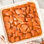 Overhead view of baked candied yams covered in a glossy butter and brown sugar sauce