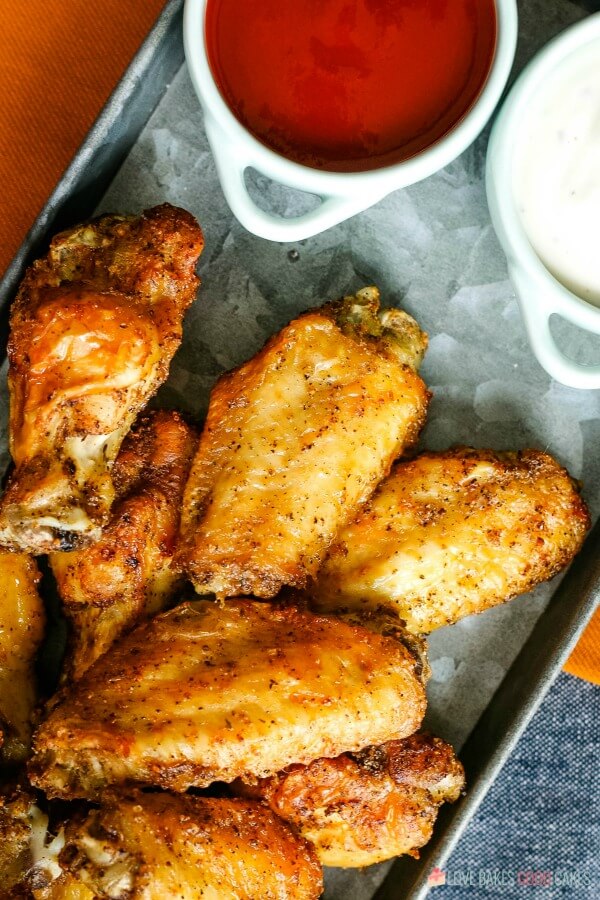 finished air fryer wings on a serving tray with sauces ready for dipping! 