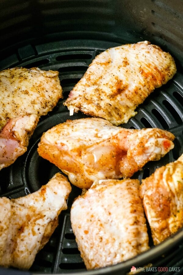 Now we see the air fryer wings being loaded into the cooking basket. 