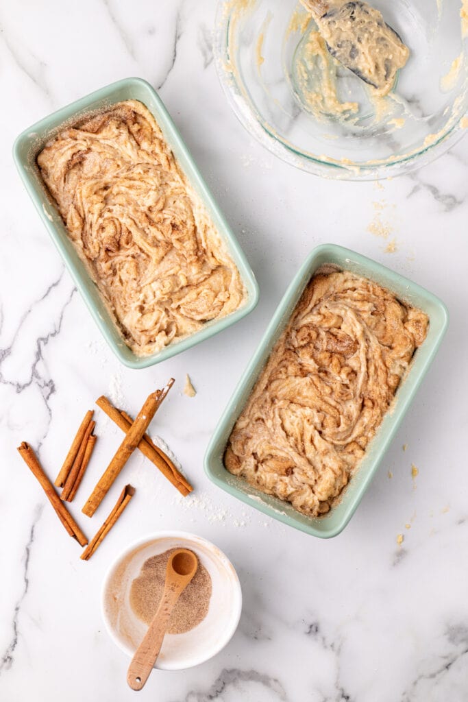 cinnamon swirled through the batter in two loaf pans just before going into the oven