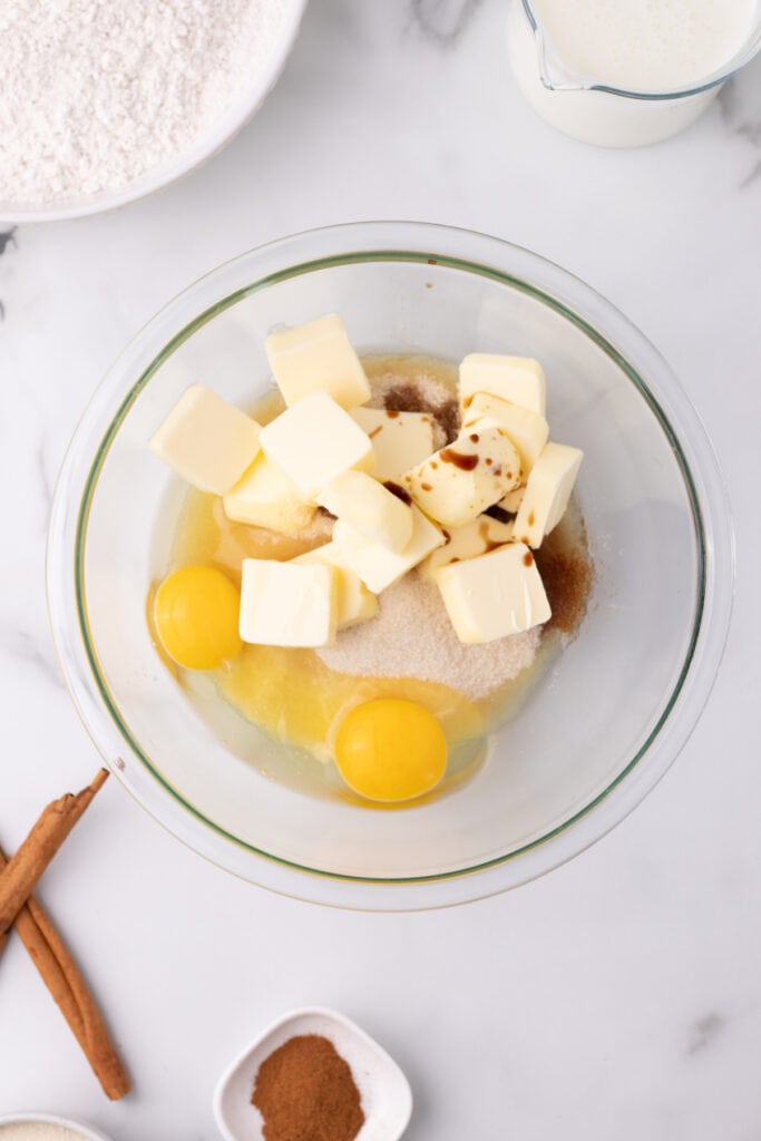 butter, eggs, sugar, and vanilla extract in a glass mixing bowl ready to be creamed together for Amish Cinnamon Bread