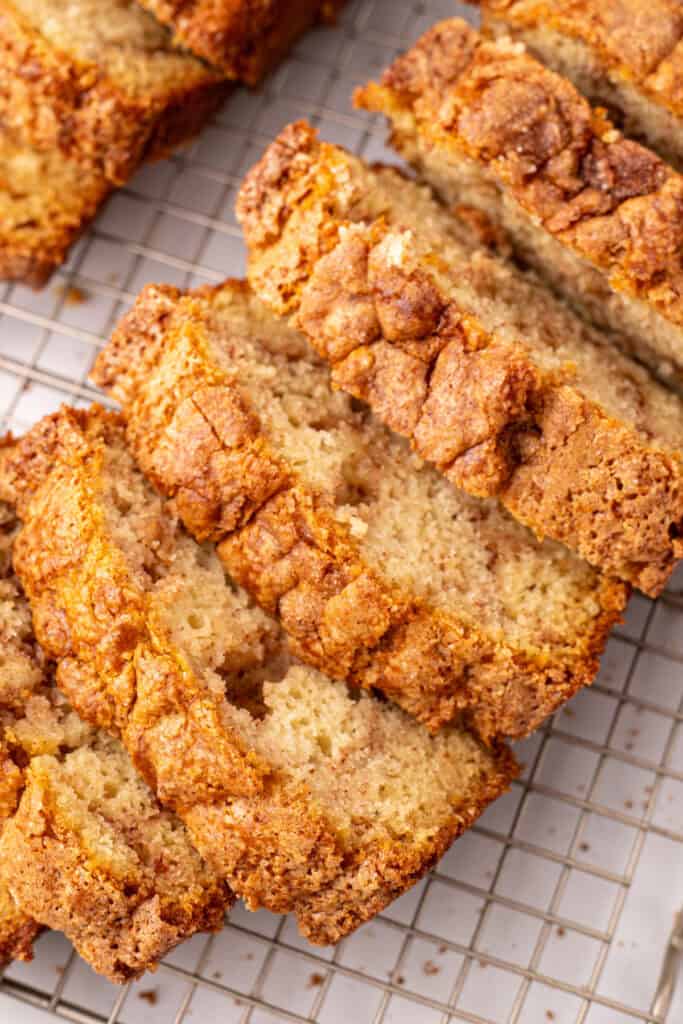 close-up overhead view of sliced Amish Cinnamon Bread showing the crackled cinnamon-sugar crust on top