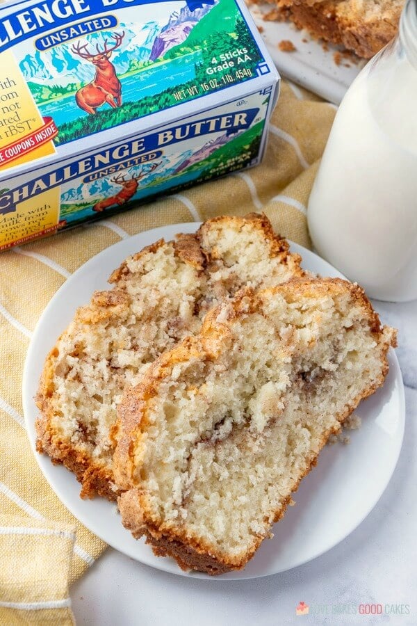 Amish Cinnamon Bread on a plate with a glass of milk and a carton of Challenge Butter.