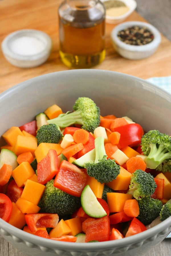 Sheet pan meals are great! This Healthy Sheet Pan Chicken and Veggies Meal is made with chicken and vegetables and makes for a great meal prep recipe! All of our vegetables go into a bowl to be seasoned before they go on the sheet pan.