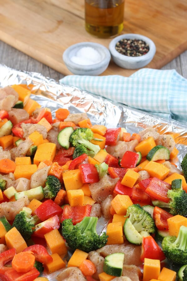 Sheet pan meals are great! This Healthy Sheet Pan Chicken and Veggies Meal is made with chicken and vegetables and makes for a great meal prep recipe! Now everything is placed on the sheet pan and ready to be baked!