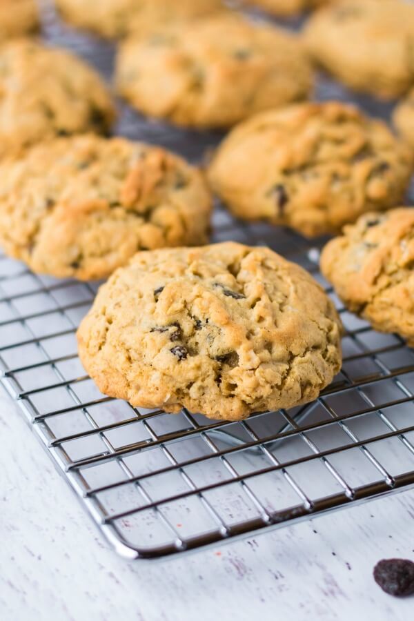 Easy recipe for the ultimate Oatmeal Raisin Cookies - slightly crunchy on the outside with a perfectly soft, heavenly chewy texture when you bite into them. cookies cooling on cooling rack