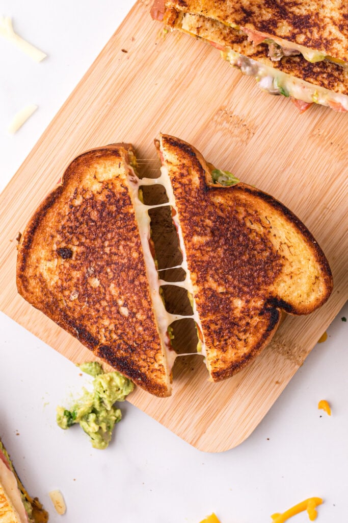 sandwich cut in half with small cheese pull