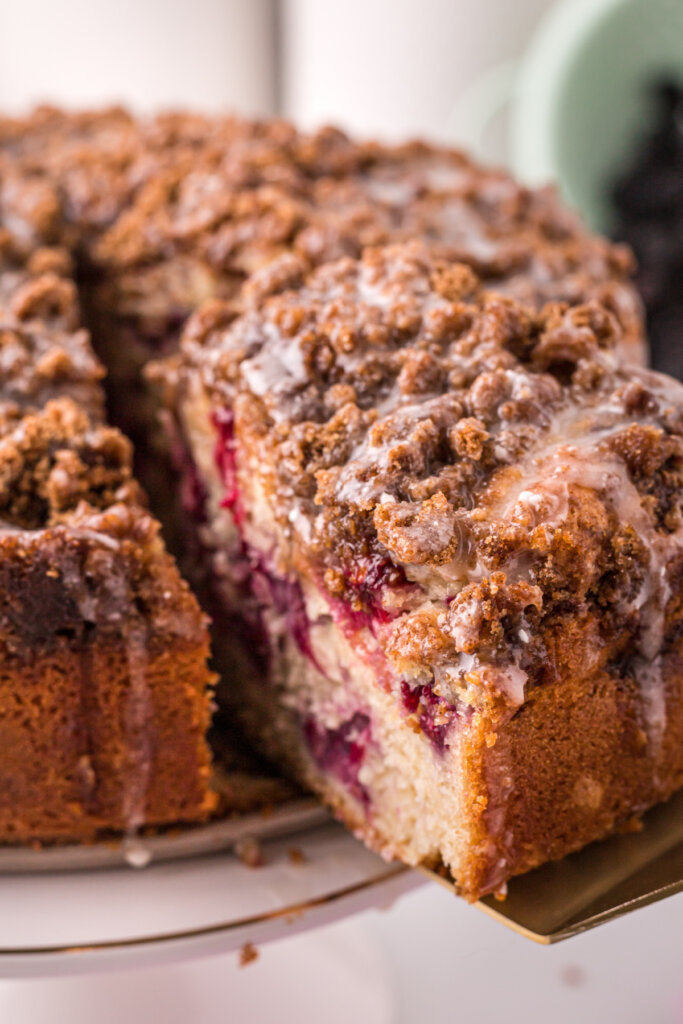 slice of coffee cake being taken out of the whole cake