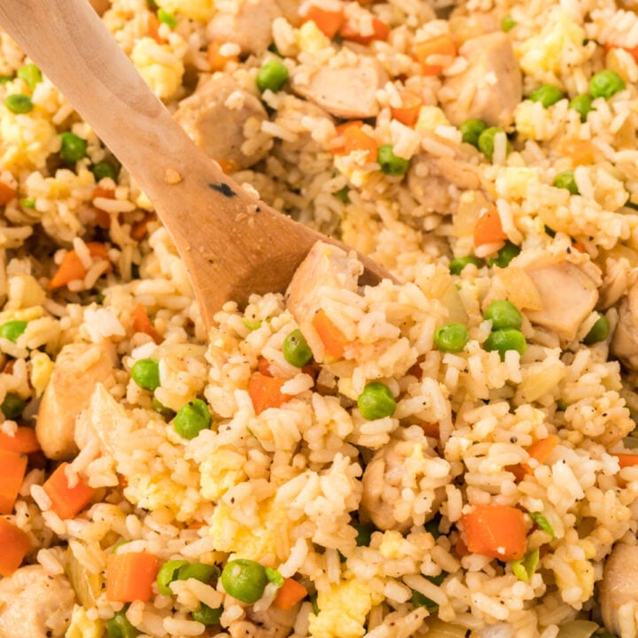 closeup of wooden spoon in chicken fried rice