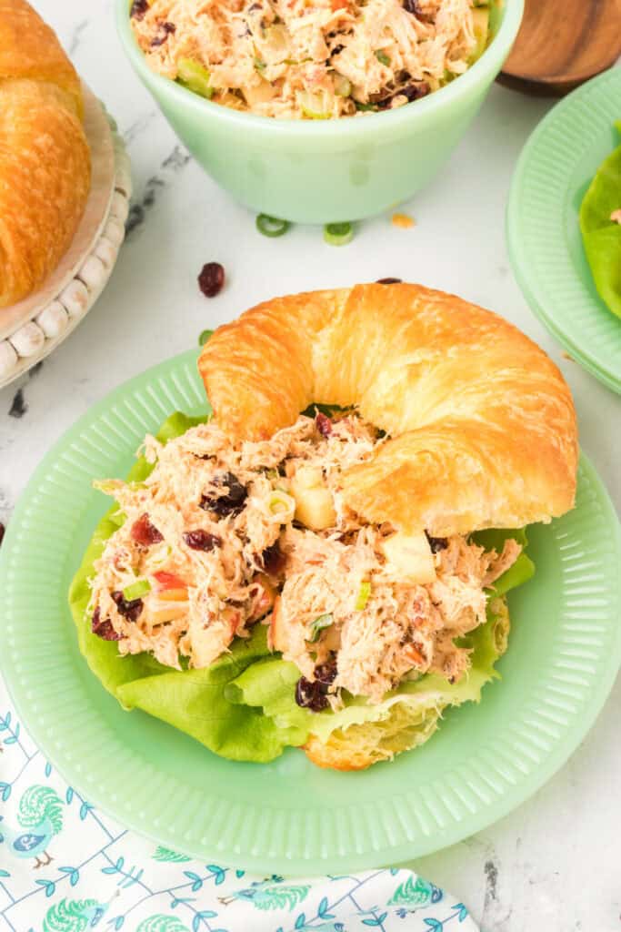 close-up of a croissant sandwich filled with chicken salad with Miracle Whip and lettuce