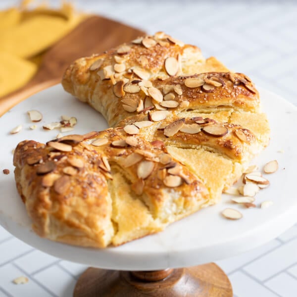 almond bear claw recipe on cake stand
