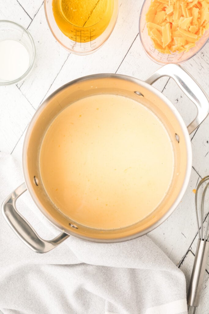 saucepan with mixture beginning to combine into a light yellow liquid