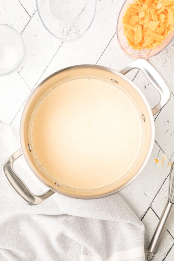 saucepan with heated mixture becoming smoother and more uniform