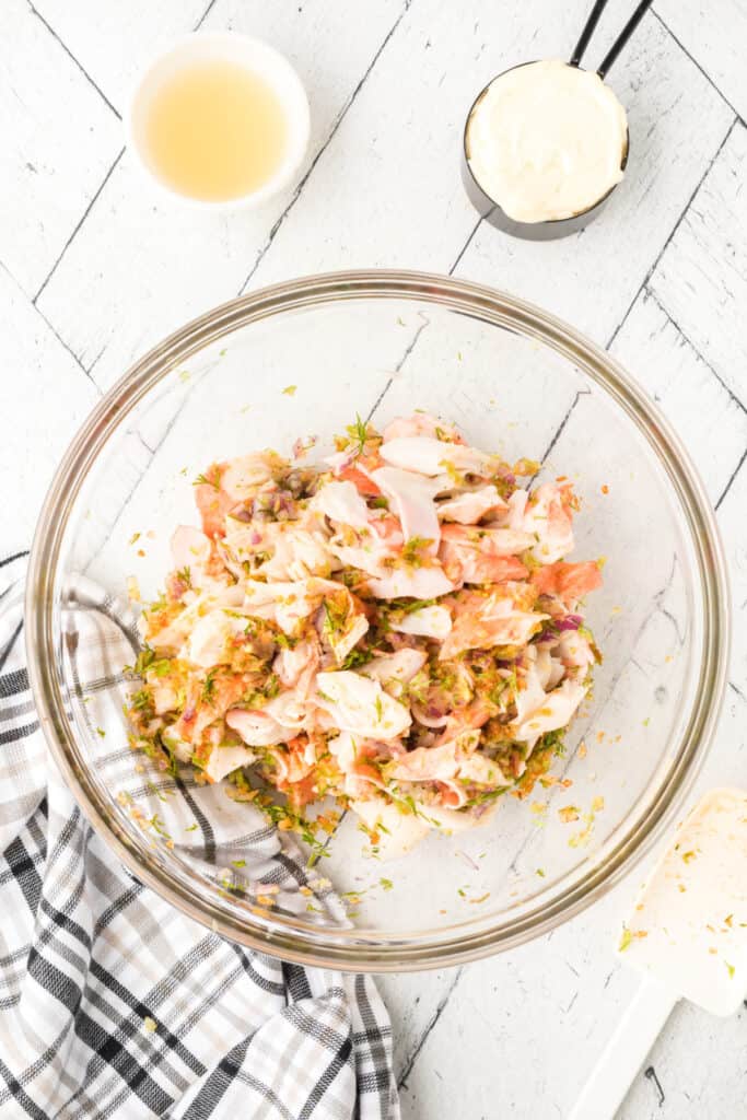 Imitation crab mixed with celery, red onion, dill, and seasonings before adding the creamy dressing for homemade crab salad.