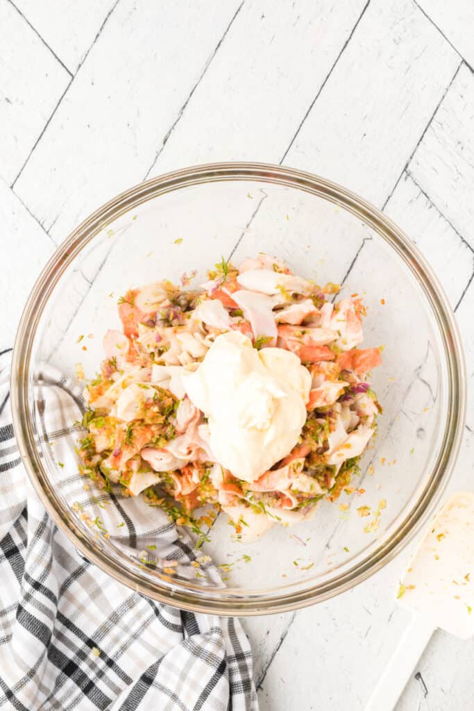 Mayonnaise added to seasoned imitation crab mixture while making homemade Deli-Style Crab Salad.