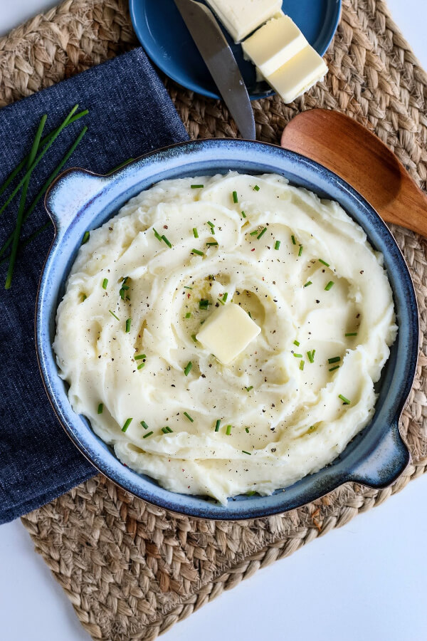 overhead shot of mashed potatoes in a blue bowl