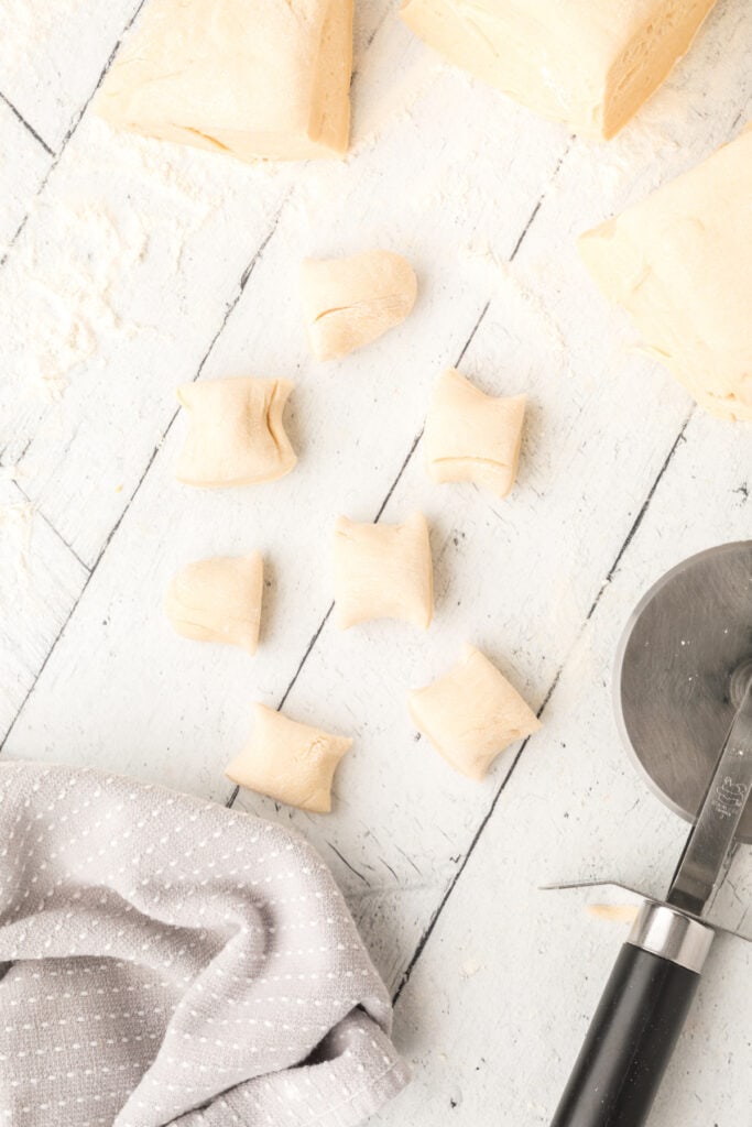 Using a pizza cutter, cut the dough in each portion into 1" bite-size segments.