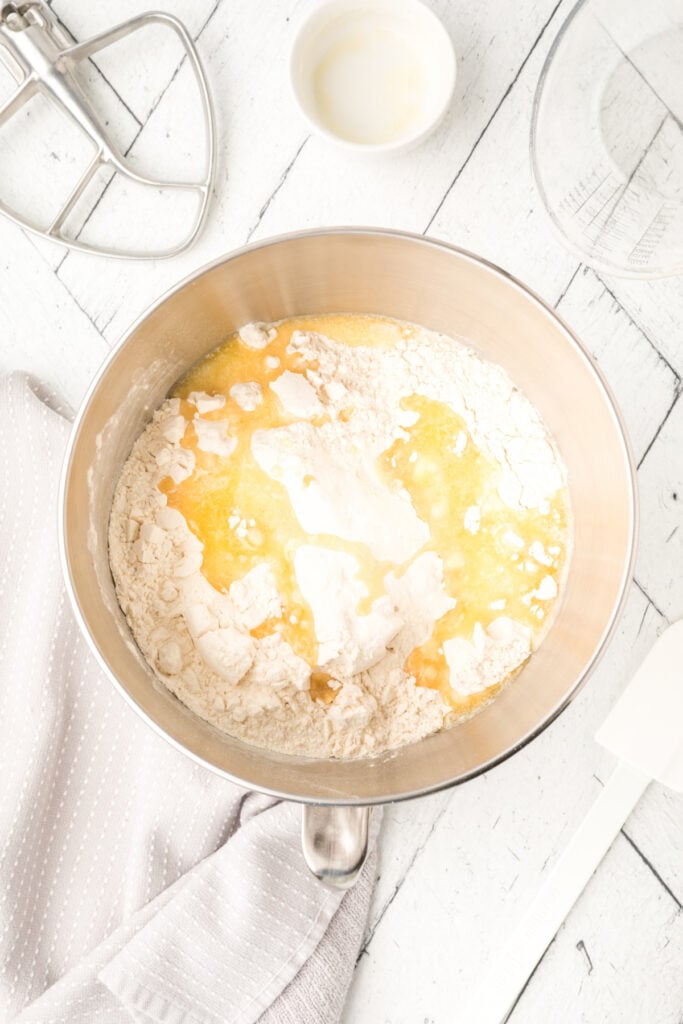 Fit the paddle attachment to the mixer. Add in the flour and melted butter and mix ...