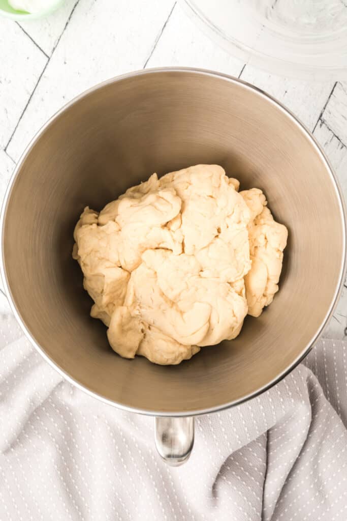 Switch to your dough hook. Knead on low until the dough is smooth and pulls away from the sides of the bowl.