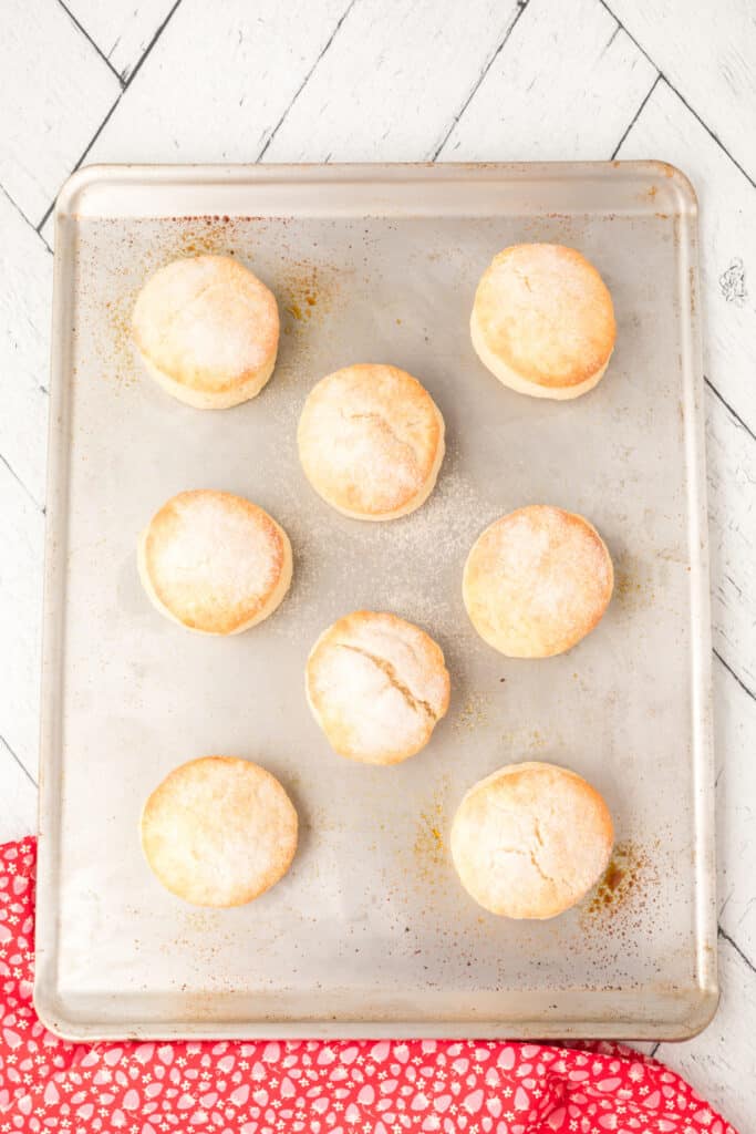 Baked biscuits on a baking sheet, dusted with sugar.