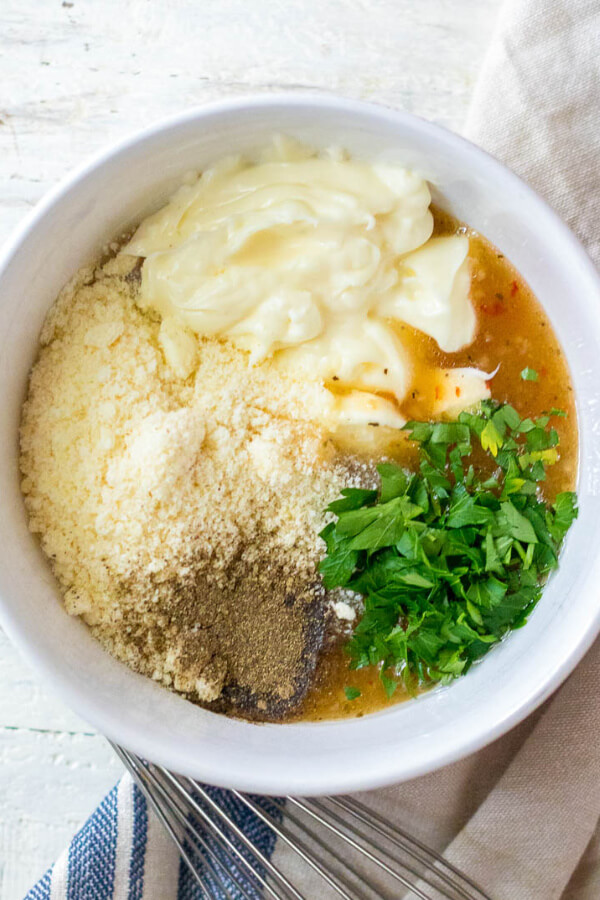 tortellini pasta salad dressing in bowl ready to be mixed