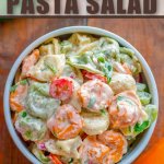 tortellini pasta salad in bowl on wooden background