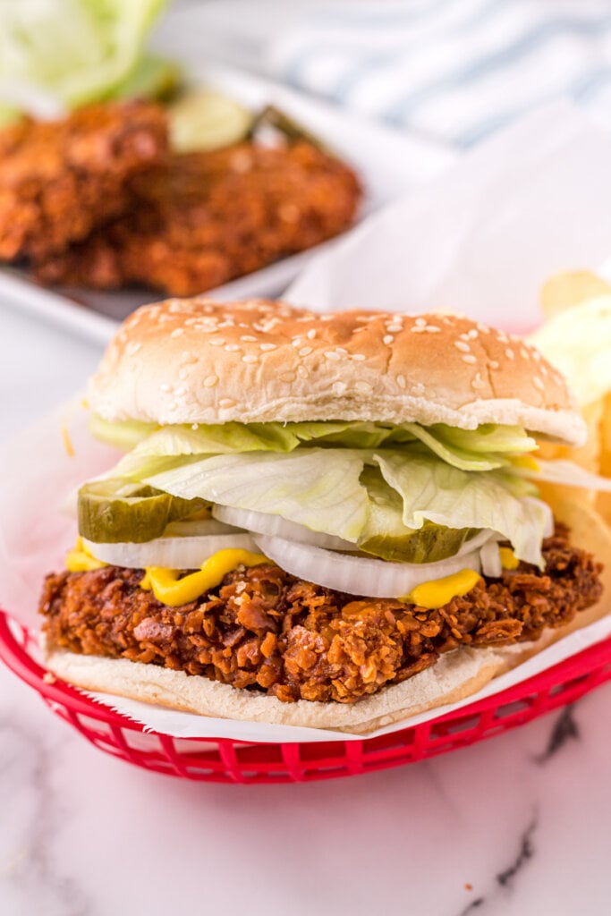 breaded pork tenderloin sandwich in red serving basket