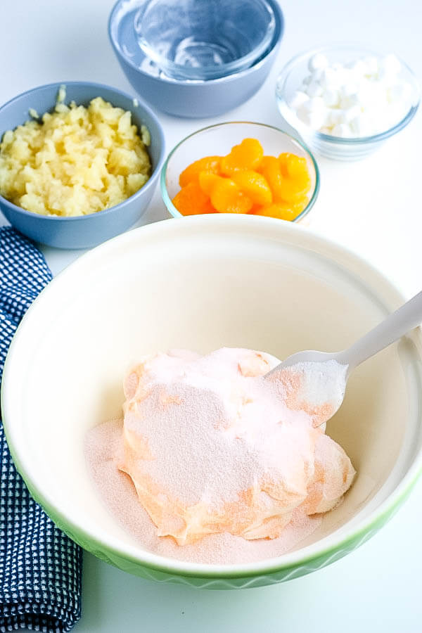 jello sprinkled over whipped topping in bowl